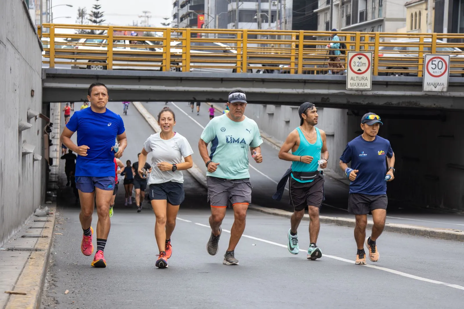 Un groupe de coureurs traverse les rues d'une grande ville au petit matin